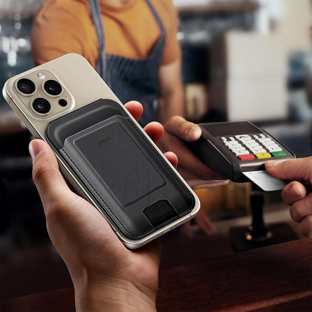 Person holds phone with attached Ugreen Magnetic Wallet 45165