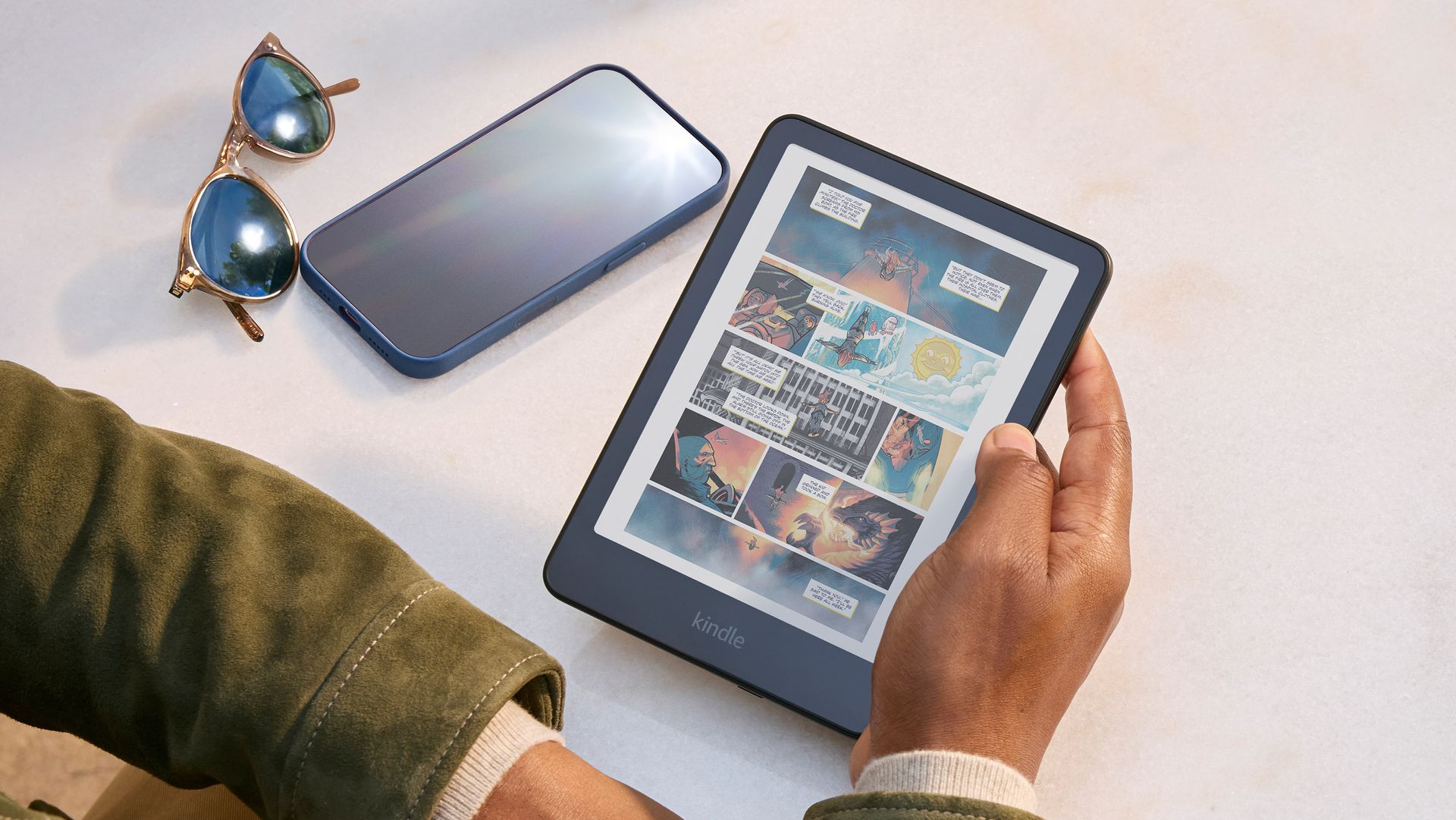 Reader holding Kindle Colorsoft displaying a color graphic novel