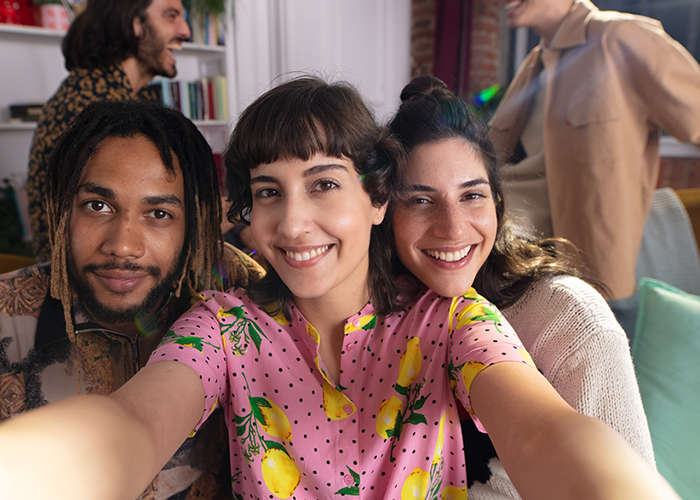 Friends taking a group selfie with the INSTAX SQUARE SQ1