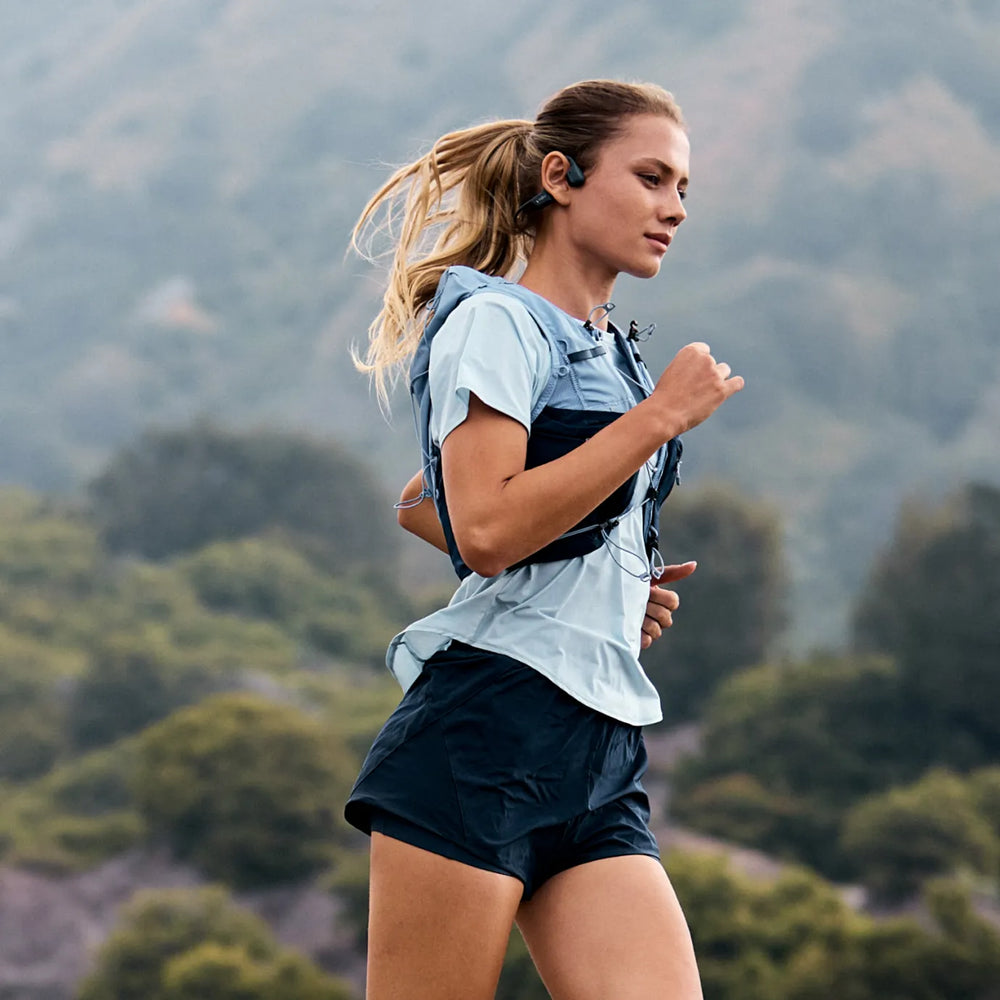Runner wearing Shokz OpenRun Pro 2 open-ear headphones