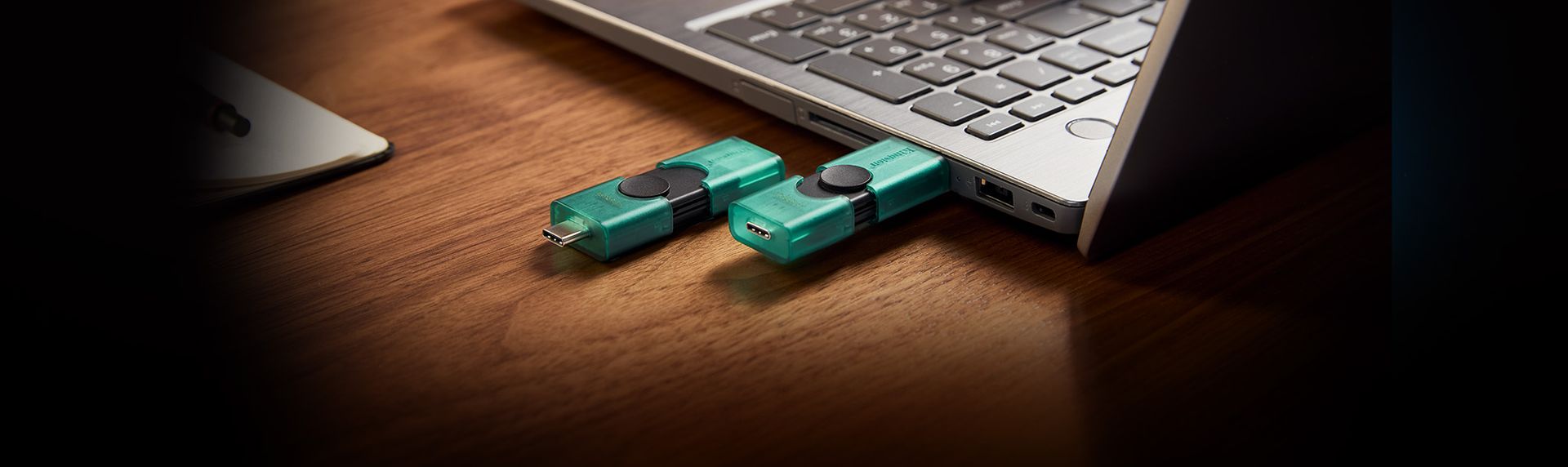 Kingston DataTraveler Duo USB drives beside a laptop